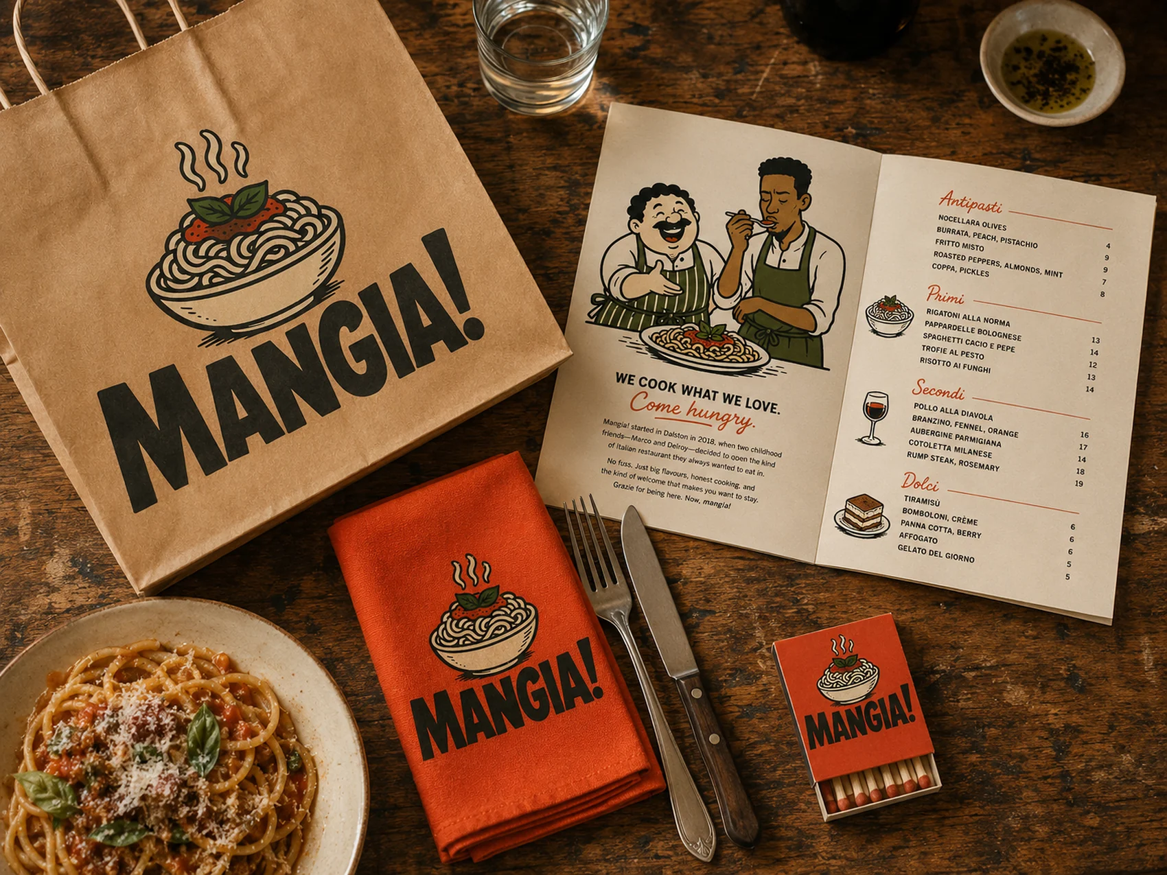 The Mangia brand applied across a table: takeaway bag, menu, napkin, matchbook and a bowl of pasta